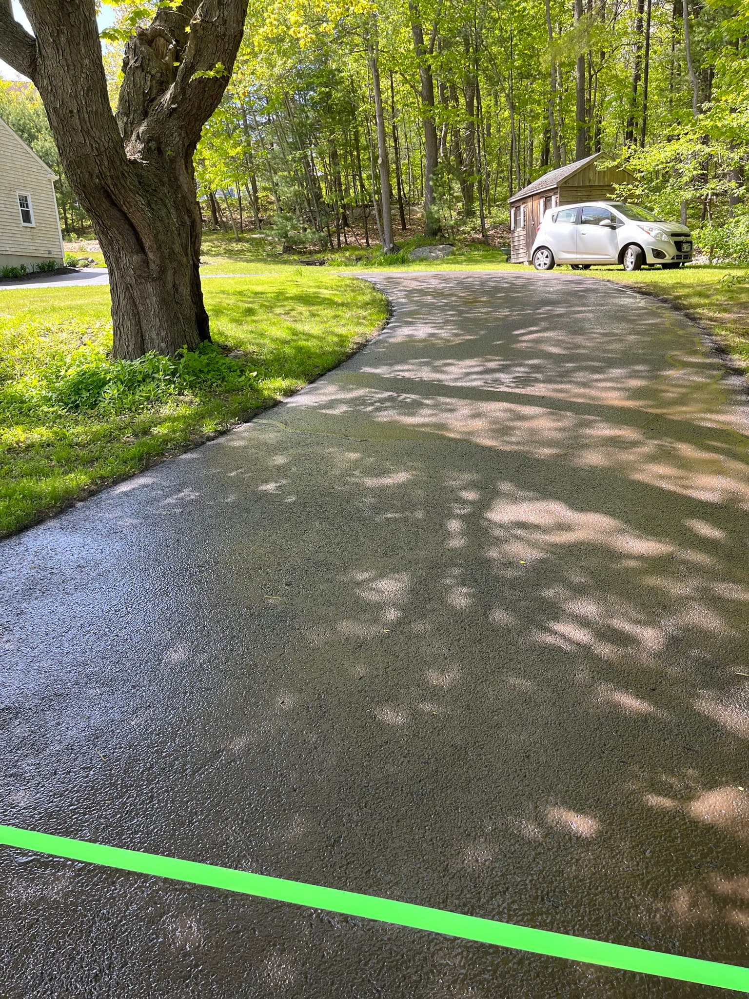 Residential driveway with walkway, sealcoat applied across the full apron area