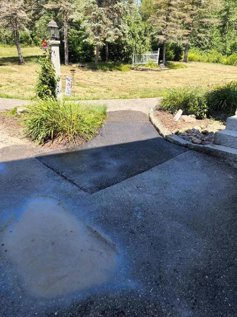 Hot-mix patch being applied, clean saw-cut edges, tamped and leveled